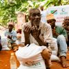 A community gathering for food distribution in an outdoor setting.